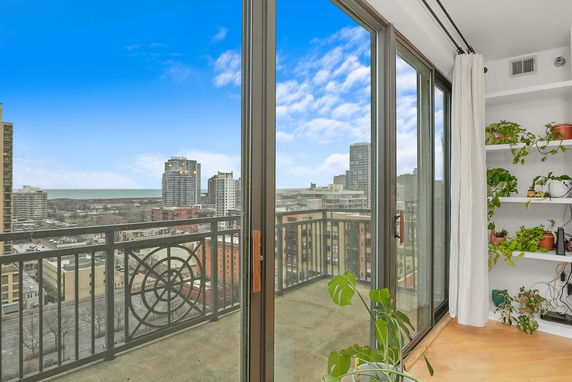 Panoramic view of a cityscape from a high-rise balcony.