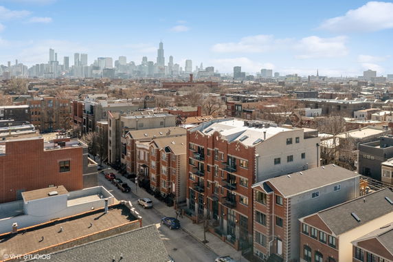 Aerial view of a cityscape with buildings and skyscrapers in the background.