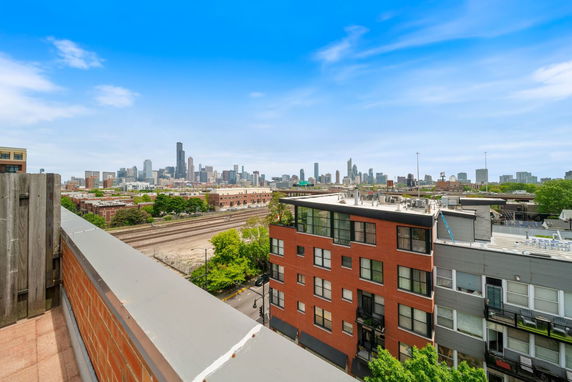 Wide angle view of a city skyline from a rooftop.