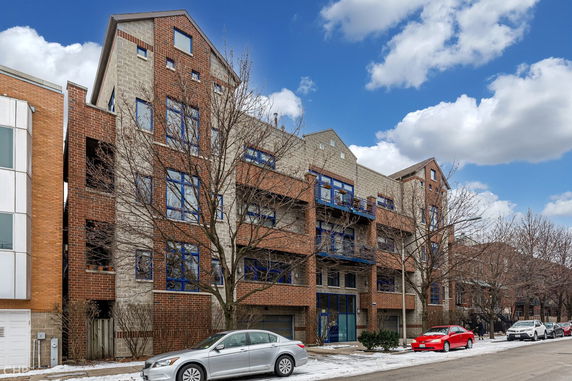 Front view of a multi-story building with brick and stone facade.