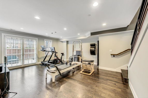 Indoor gym area with exercise equipment including a treadmill and stationary bike.