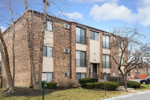 Front view of a three-story brick apartment building.