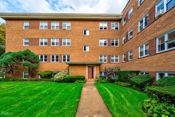 Front view of a multi-story brick apartment building.