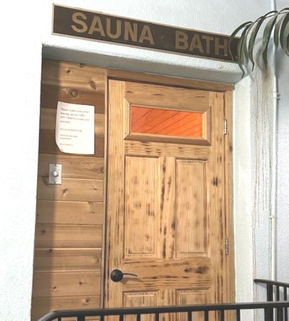 Entrance to a sauna bath room with a wooden door.