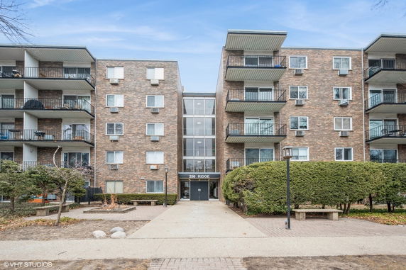 Front view of a multi-story apartment building with balconies.