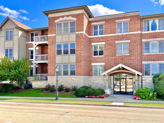 Front view of a multi-story building with brick and stone facade.