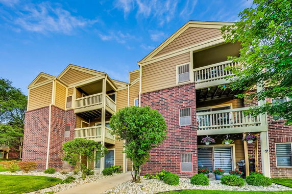 Front view of a multi-story residential building with balconies.