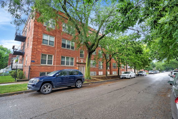 Front view of a multi-story brick apartment building.