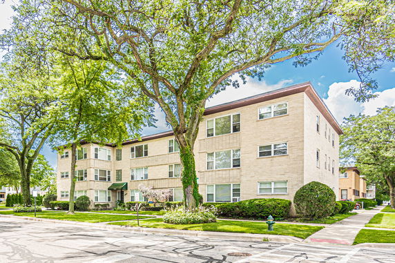 Front view of a three-story apartment building with brick exterior.