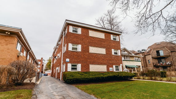 Front view of a multi-story brick apartment building.