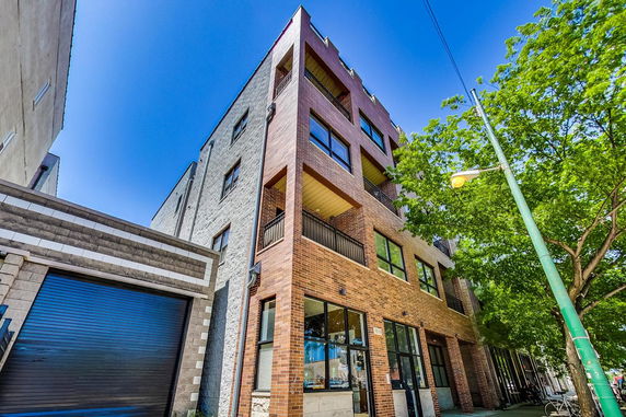 Front view of a multi-story building with a modern brick design.