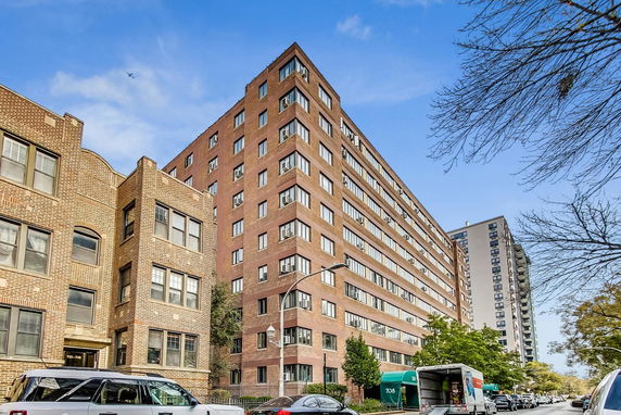 Front view of a large multi-story brick residential building.