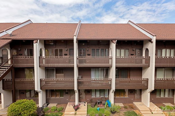 Front view of a multi-story building with balconies on each floor.