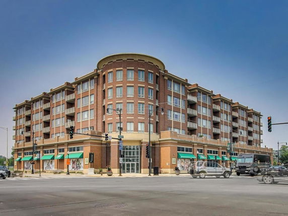 Front view of a multi-story building with commercial sections on the ground floor and residential units above.