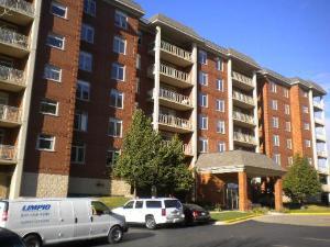 Front view of a multi-story brick apartment building.