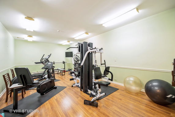 Indoor gym area with exercise equipment and fitness machines.