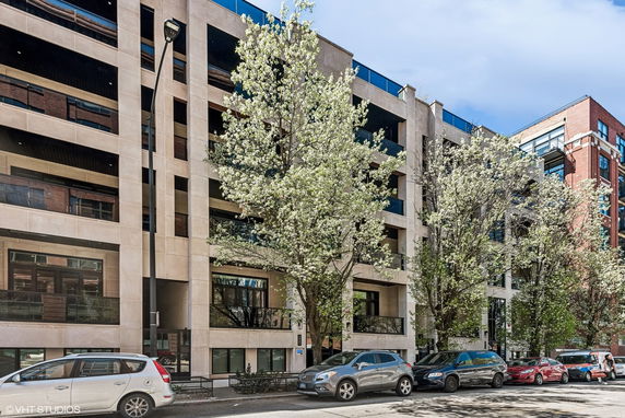 Front view of a multi-story residential building with balconies.