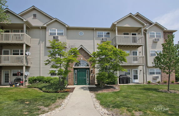 Front view of a multi-story residential building with balconies.