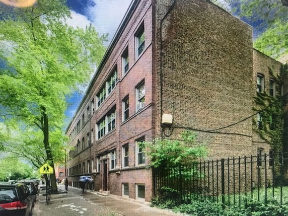 Front view of a multi-story brick building.