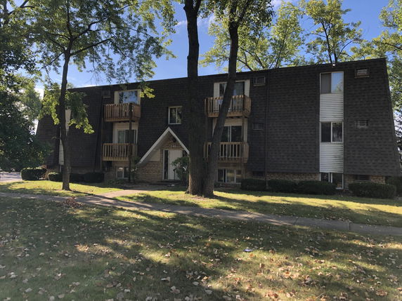Front view of a multi-story residential building with balconies.