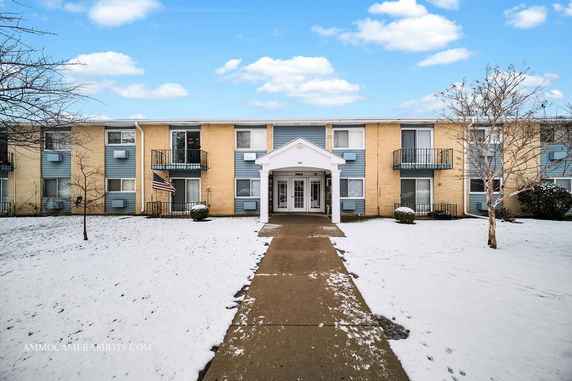 Front view of a two-story apartment building with a central entrance.
