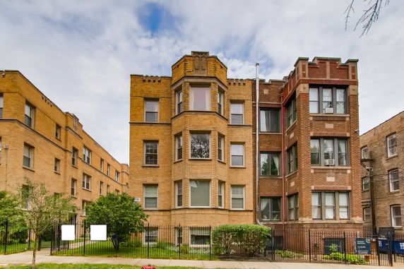 Front view of a multi-story brick apartment building.