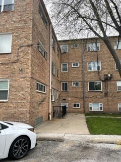 Front view of a brick apartment building with multiple floors.
