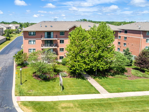 Front view of a multi-story brick apartment building.