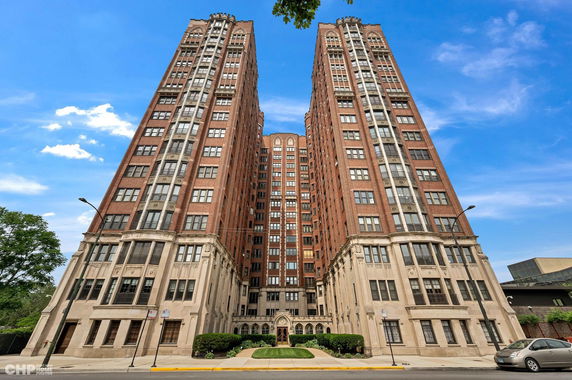 Front view of a tall, multi-story brick building.
