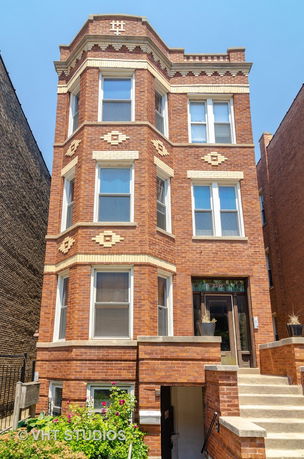Front view of a multi-story brick building.