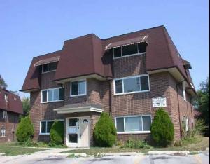 Front view of a two-story brick building with a dark roof.