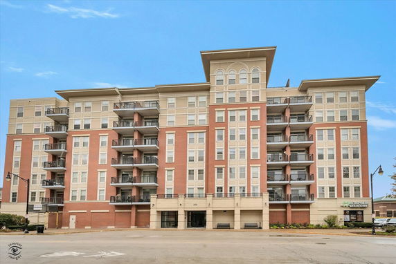 Front view of a multi-story residential building with balconies.