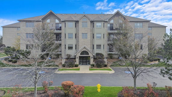 Front view of a multi-story apartment building with a central entrance.
