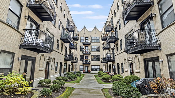 View of an apartment building with multiple balconies.