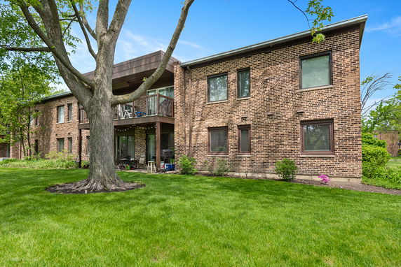 Front view of a two-story brick building with a balcony.