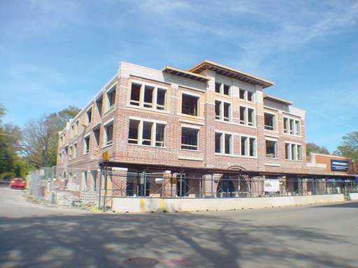 Front view of a multi-story brick building under construction.