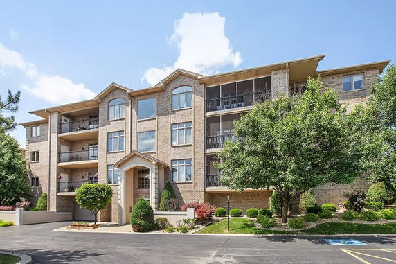 Front view of a multi-story residential building with balconies.