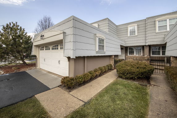 Front view of a two-story house with a garage.