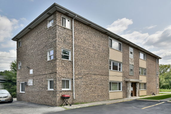 Front view of a three-story brick apartment building.