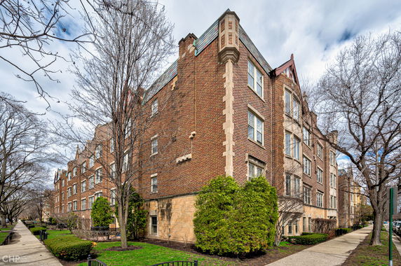 Front view of a multi-story brick building with detailed masonry.
