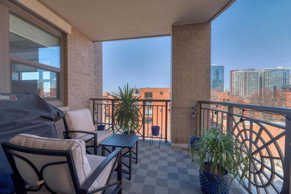 Balcony view from a building showing surrounding cityscape.