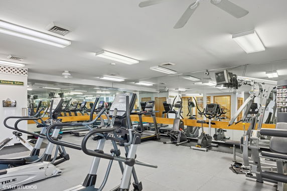 Interior view of a gym with various exercise equipment.