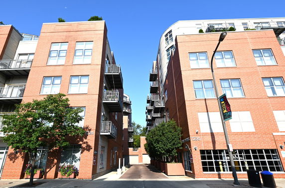 Front view of modern multi-story brick buildings with balconies.