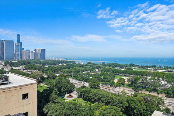 Wide angle view of cityscape and lake from a high vantage point.