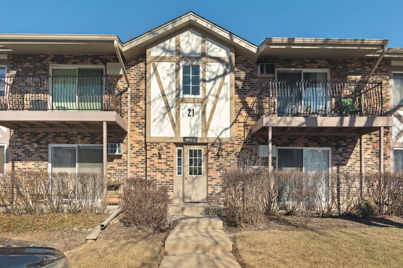 Front view of a two-story brick building with balconies.