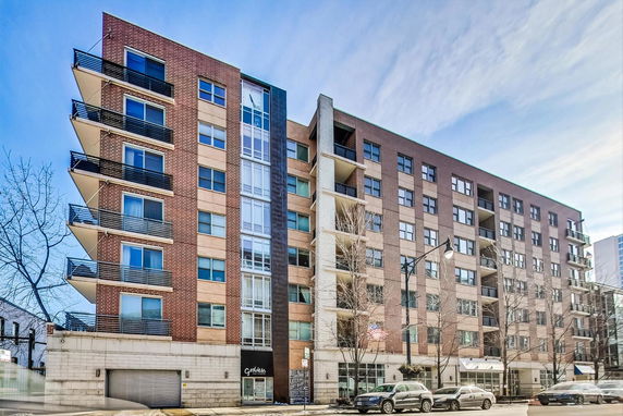 Front view of a multi-story apartment building with balconies.