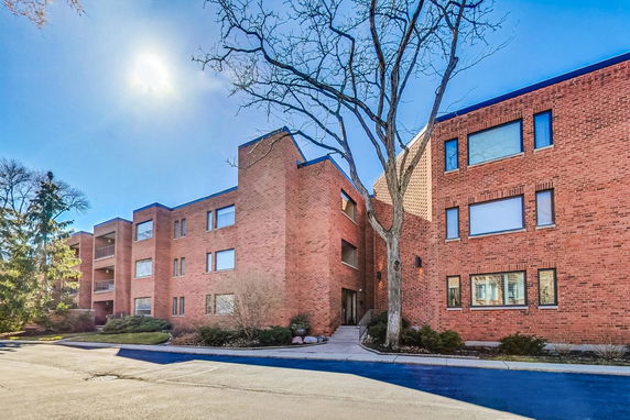 Front view of a brick residential building with multiple floors.