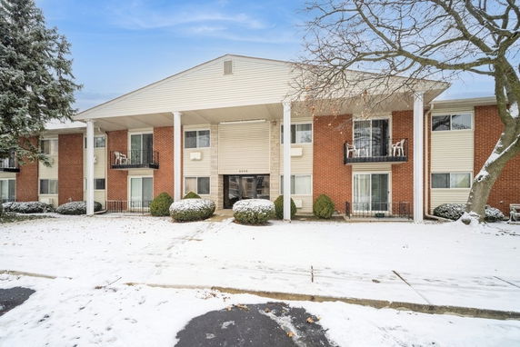 Front view of a two-story apartment building with brick and siding exterior.