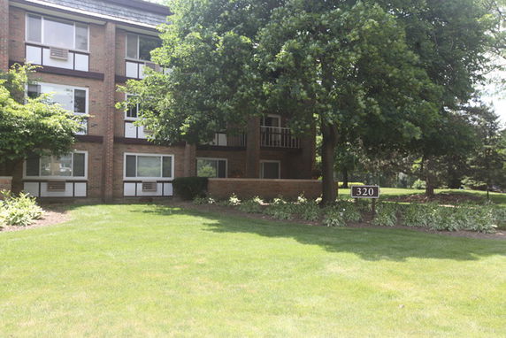 Front view of a multi-story brick building with balconies.