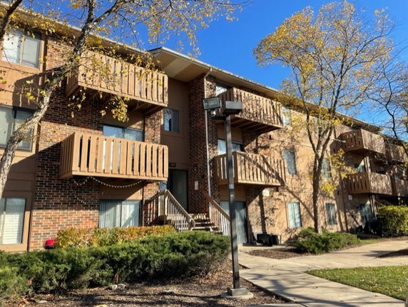 Front view of a multi-story residential building with balconies.